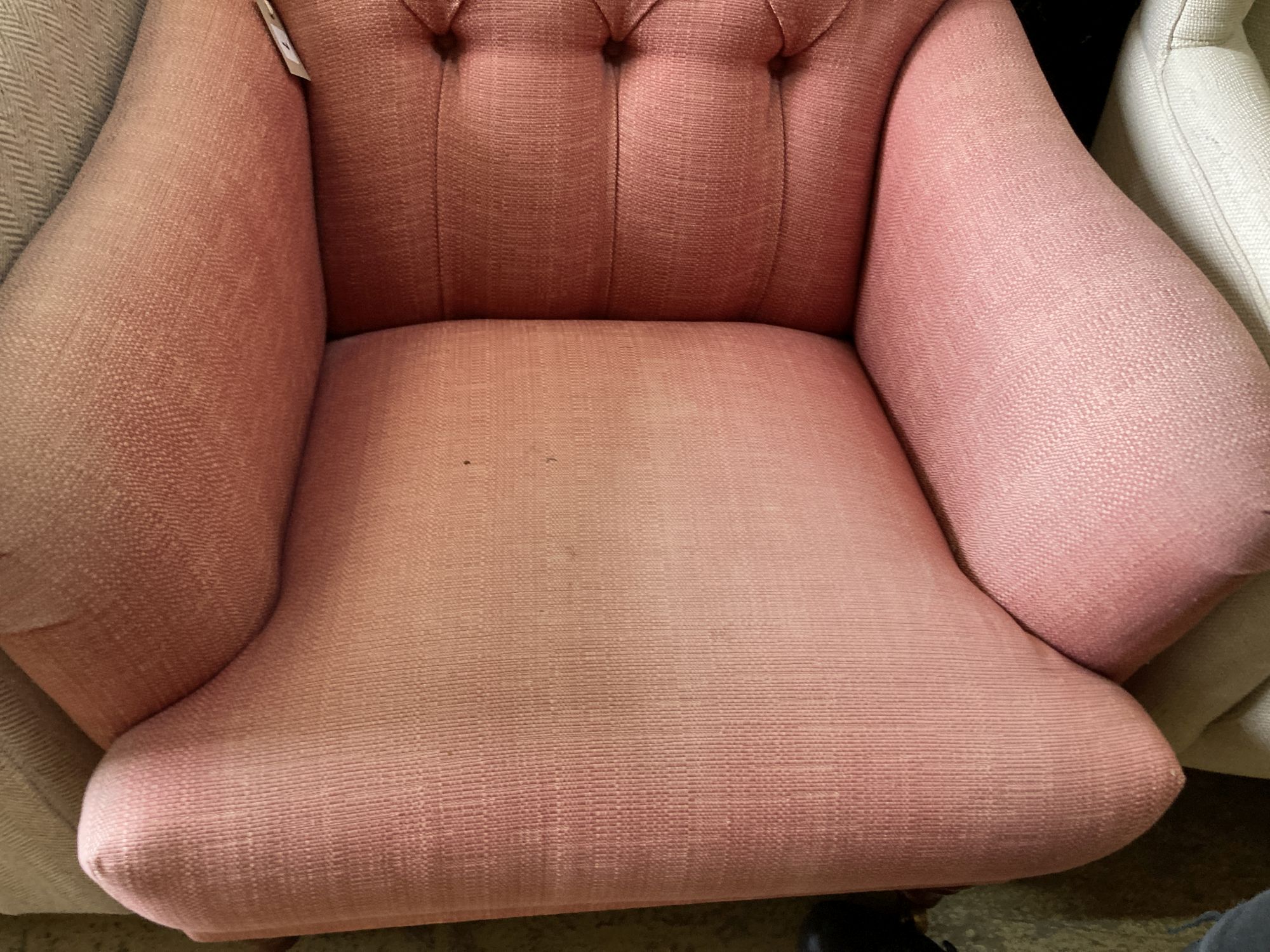 A contemporary buttoned upholstered armchair, length 80cm, depth 90cm, height 96cm